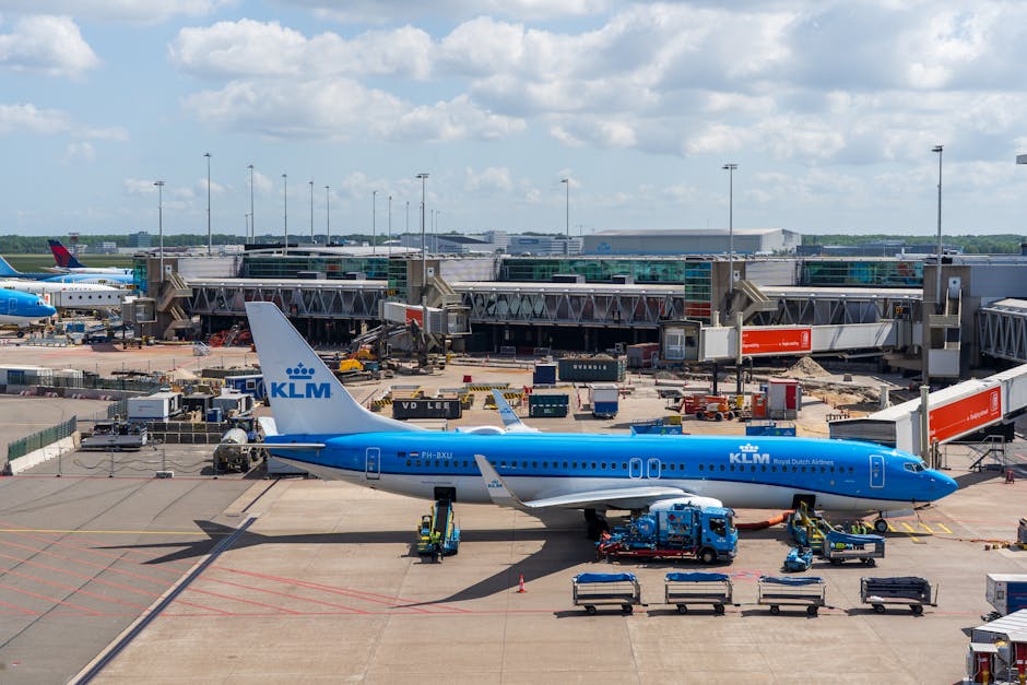 A KLM aircraft at a bustling airport terminal, showcasing international travel.