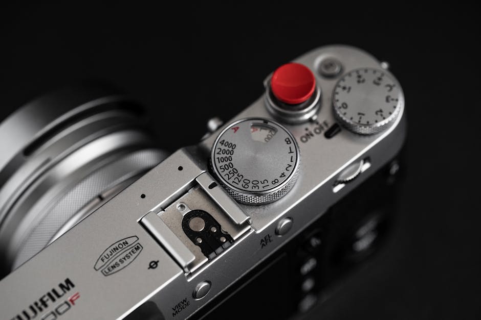 Detailed view of a vintage style camera's top, showcasing dials and buttons.